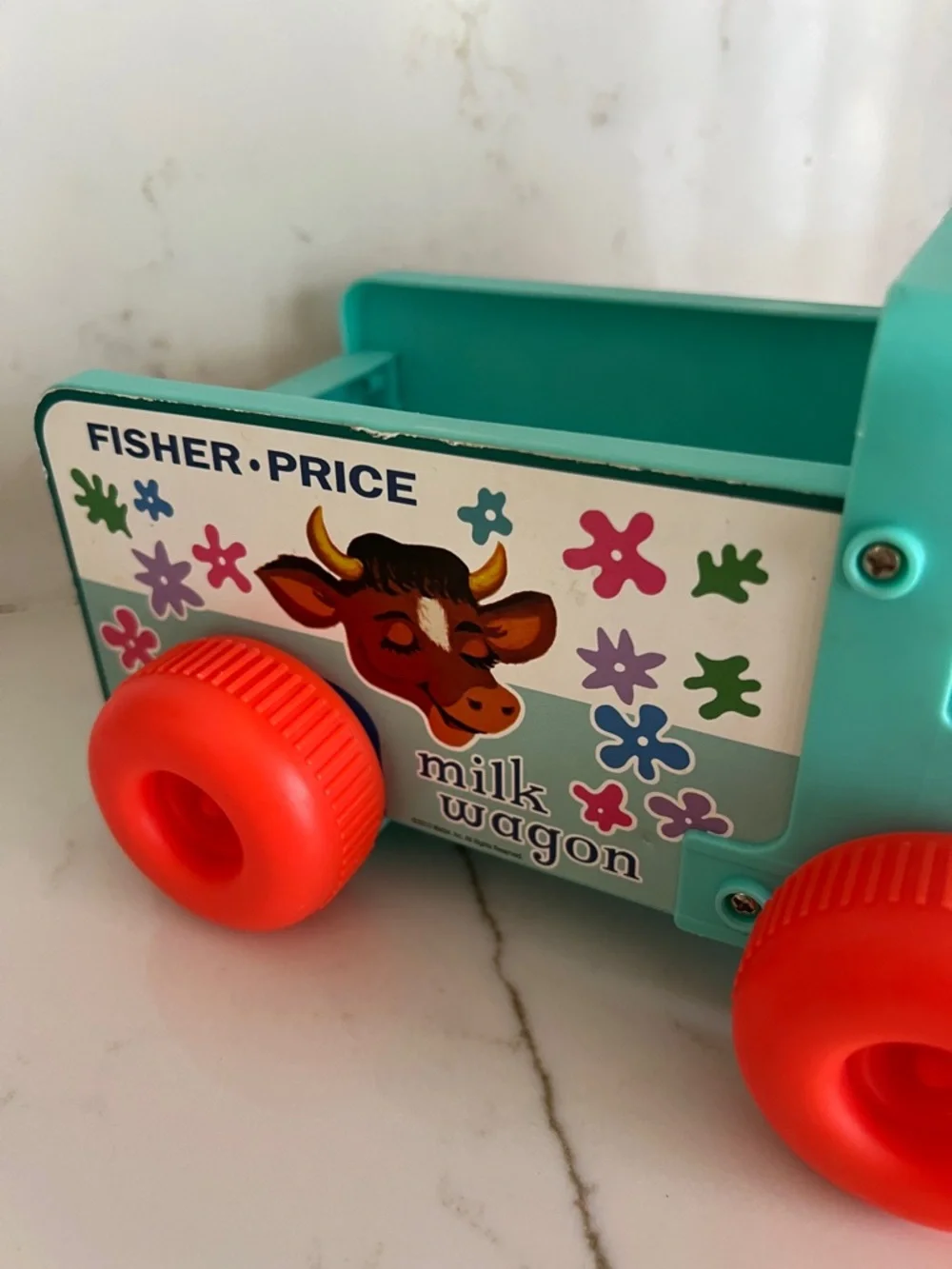 Fisher-Price Teal Milk Wagon Pull Toy with Bright Orange Wheels